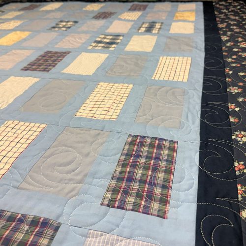 Close up of quilt with blue trim